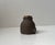 Aa very rare small canister or jar intended for storing Hash. Executed in brown ceramic with text in white salt glaze....