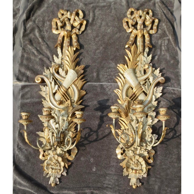 Antique Italian hand-carved, three-light giltwood sconce, 19th or early 20th century. A long and elaborate Italian-style...