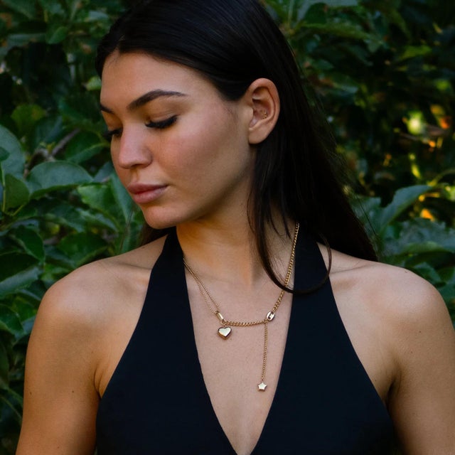 Shine with elegance and charm in our Stellar Love Statement Heart Necklace. Featuring a sleek gold-plated design with a...