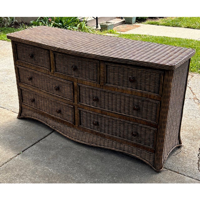 Coastal skirted wicker bow front dresser with seven drawers. Color is a rich chocolate brown with coordination wooden...