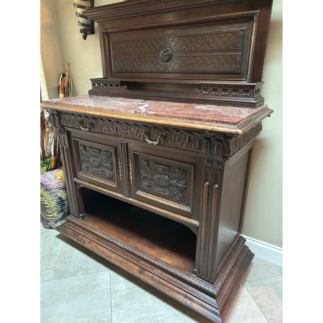 Late 19th-Century European Renaissance Revival Carved Buffet with Marble Top An impressive and highly decorative...
