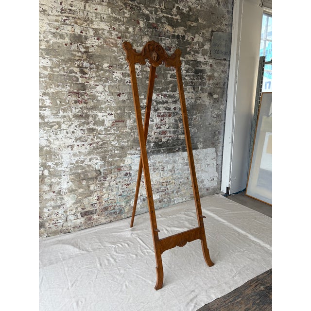 This elegant antique wooden easel frame offers a timeless, decorative touch for displaying art, mirrors, or signage....
