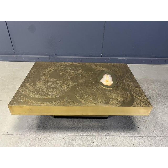 Exceptional etched brass coffee table with a beautiful inlaid agate stone and a black lacquer and brass base. This hand...
