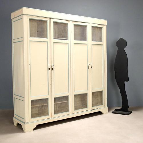 Lacquered fir pantry cabinet. Front with four tripartite doors, central wooden panel, upper and lower with mesh. Italy,...