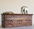 Small Tibetan low table in softwood, carved on three sides with a repeating scrolling motif set within recessed panels,...