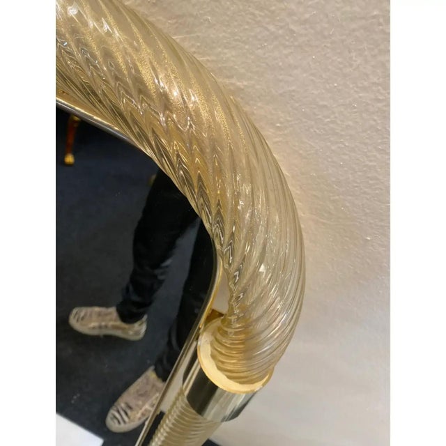 Rectangular gold “torciglione” murano glass wall mirror. scenographic wall mirror in brass elements with trasparent ando...