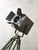 A green-patinated Strand Electric Patt 45, one of the most recognized names in British stage lighting, standing on a...