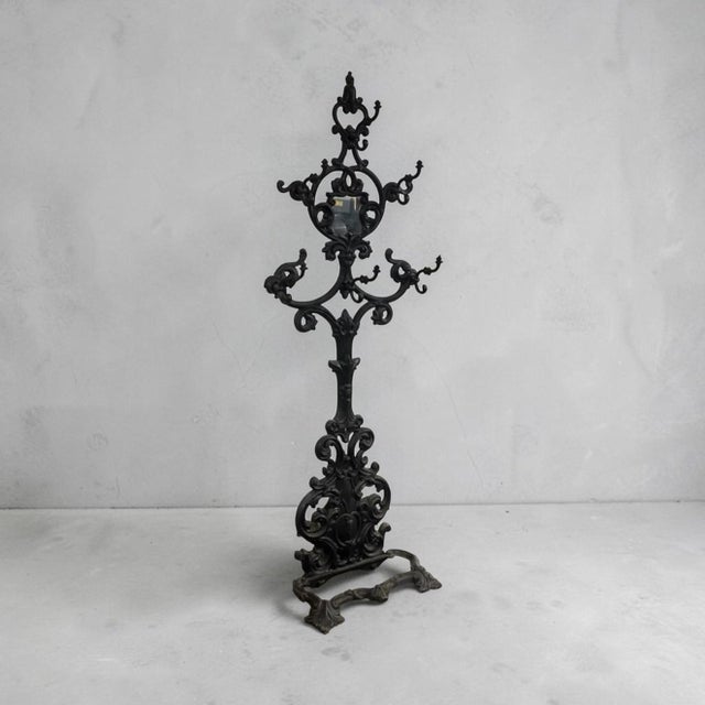 Antique Victorian Rococo Revival cast iron hall tree featuring ornate scrollwork, foliate details, and an openwork lace-...