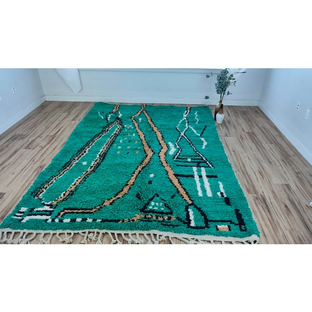 A saturated emerald-green Beni Mrirt, crossed by camel-tan and black abstract branching linework — part lightning bolt,...