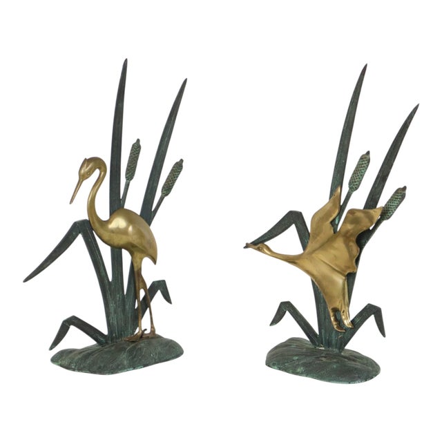 A beautiful set of two mid-century modern figurines—stylish brass sculptures depicting a heron and a flying duck, set...