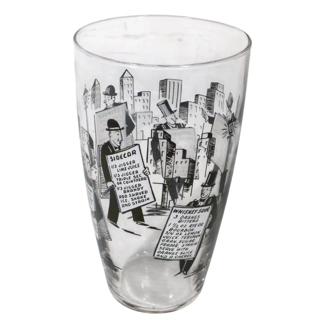 Vintage cocktail mixing glass from the Sandwich Man series attributed to the Libbey. Glass Company The glass features a...