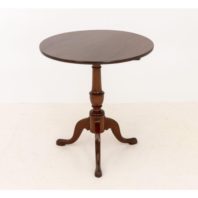American Mahogany Tripod Table, the tilt top above a vasiform stem atop three cabriole legs. Top tilted: 43.5" H x 26.75"...