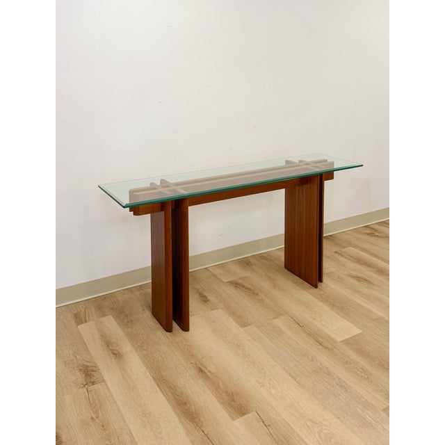 This vintage Danish console table showcases a distinctive puzzle construction, a hallmark of Danish mid-century design...