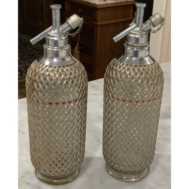 Metal Sparklets Ltd. London, English Seltzer Bottles / Soda Siphons With Original Straws, Red Fill Bands & Woven Metal Mesh - Mid-20th Century Pair For Sale - Image 7 of 12