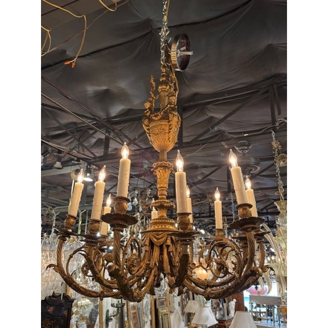 19th century French Louis XVI gilt bronze 12-arm chandelier. A French Louis XVI chandelier embodies the neoclassical...