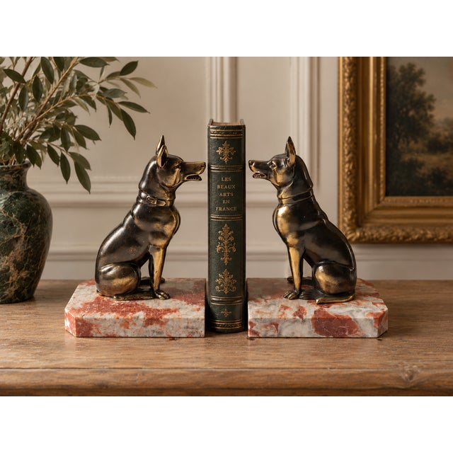 A striking pair of French Art Deco bookends featuring two beautifully modeled seated dogs, signed Jamar, circa 1930. Each...