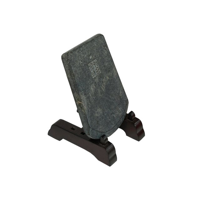 Discover a piece of ancient artistry with this exquisite stone tablet, possibly a gong stone or a writing implement from a...