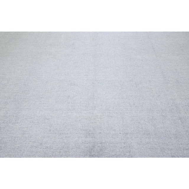 This exquisite contemporary wool and silk rug showcases a striking gray-silver base adorned with a stunning geometric...