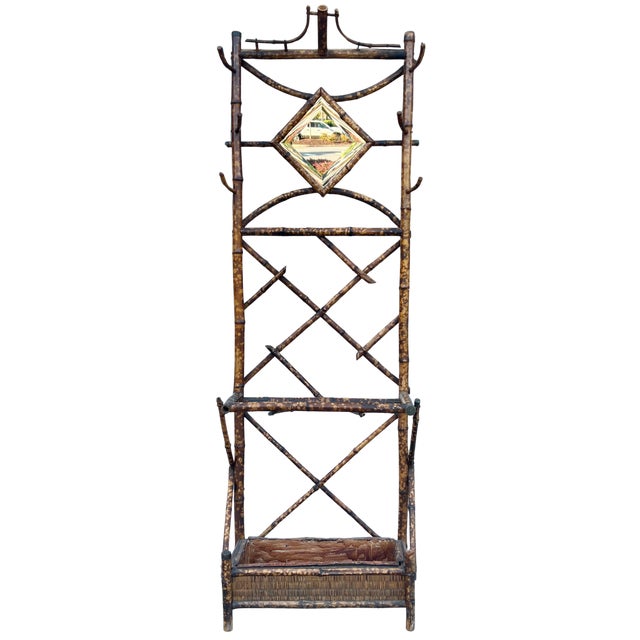 A charming antique English bamboo hall tree dating to the 1920s, full of character and beautiful aged detail. The warm,...