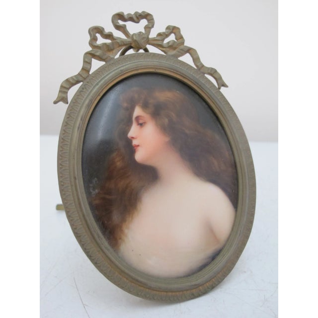 Beautiful 19th century hand painted porcelain plaque showing a delicate portrait of woman with long locks, in the manner...