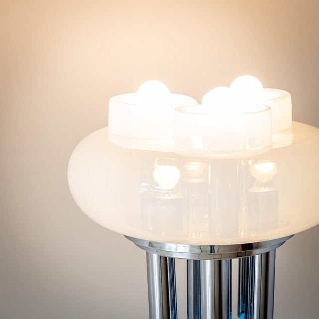 Tubular steel floor lamp with white transparent Opaline glass shade and two separately switchable light settings. The...
