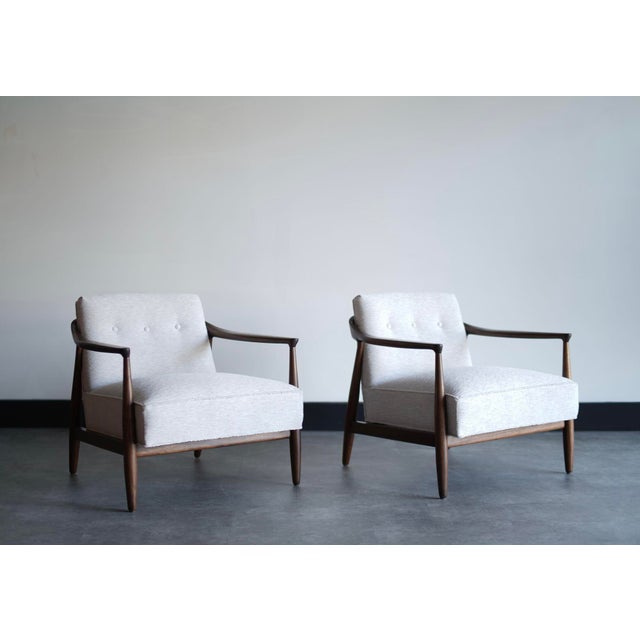 A stunning set of sculptural walnut lounge chairs by Erwin Lambeth, circa 1950s. Expertly restored to highlight the...