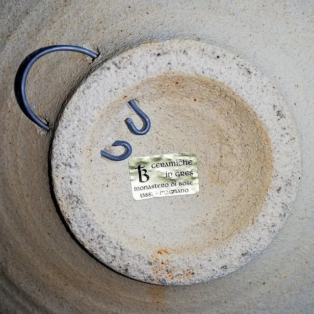 This ceramic dish has abstract, polychrome decor. It is signed 'TB' and comes with a label 'stoneware Monastery of Bose,...