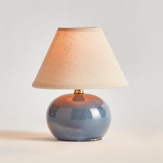 This sweet little blue glazed ceramic lamp is at home in any coastal setting. The texturedCream shade and petite base make...