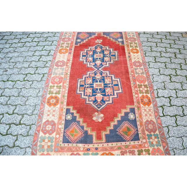 This is a vintage Turkish Oushak rug from the 1960s. The piece was hand-knotted.