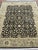 Indo Agrah rug, hand knotted in India from 100% wool. Measuring 8’ x 10’10”, the rug features a rich black field decorated...