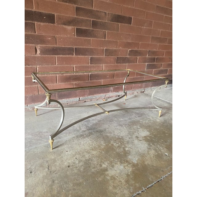 This exquisite Maison Jansen Italian Hollywood Regency Polished Steel and Brass Coffee Table exudes elegance and...