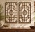 A set of two matching fretwork panels, built from fine wooden bars in a pattern of squares and rectangles, with a...