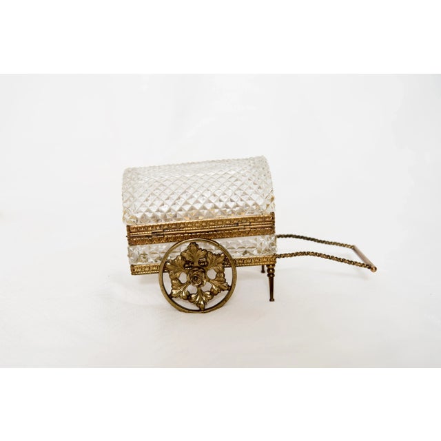 A very rare vintage cut crystal jewelry casket/carriage with bronze mounts. The domed crystal casket sits on a bronze...