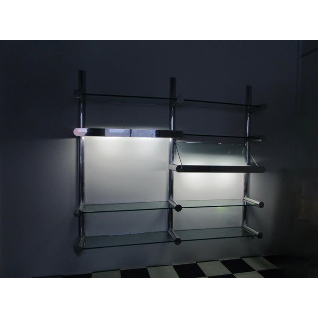 Impressive wall system of extruded polished aluminum half cylinder uprights with full cylindrical horizontal arms...