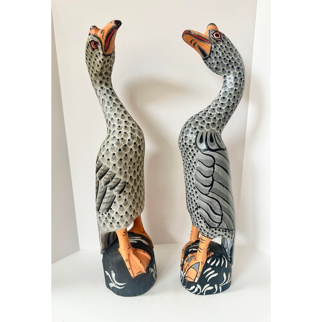 Beautiful and unique pair of large hand carved and painted geese sculptures. Carved from large single pieces of wood and...