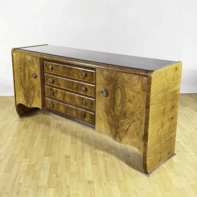 This imposing art deco sideboard, dating back to the 1930s, embodies the sophisticated elegance of turn-of-the-century...