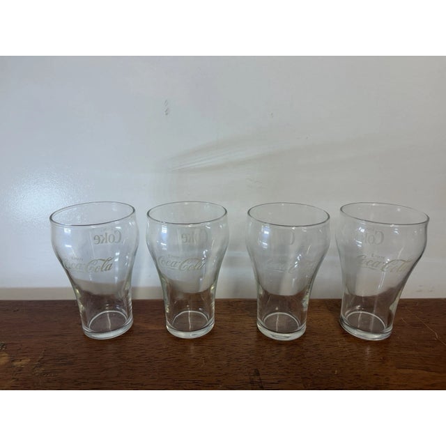 Set of 4 clear Coca-Cola contour-style drinking glasses with classic Coke logos. Great for everyday use, a home bar, or...