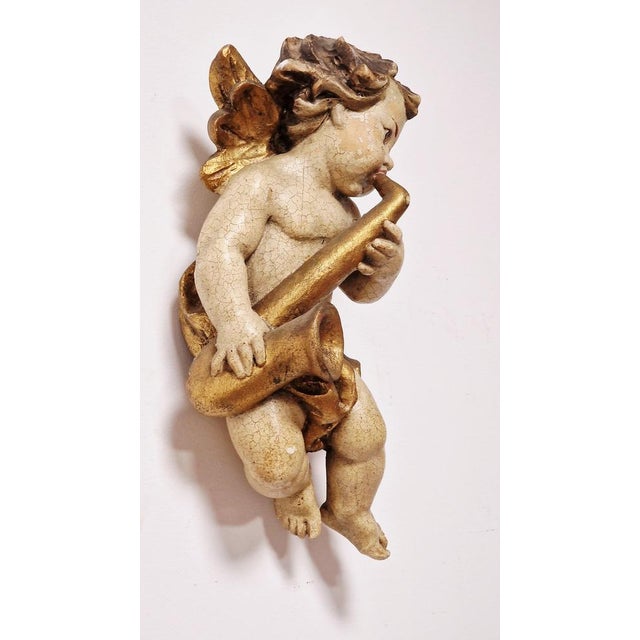 Made of wood, often maple or Swiss pine, hand-finished by master craftsmen. It features a polychrome finish with gold leaf...