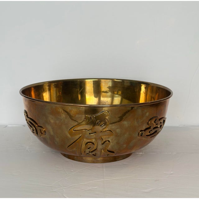 We are very pleased to offer a striking vintage brass bowl, circa the 1960. This piece features intricate cut-out designs...