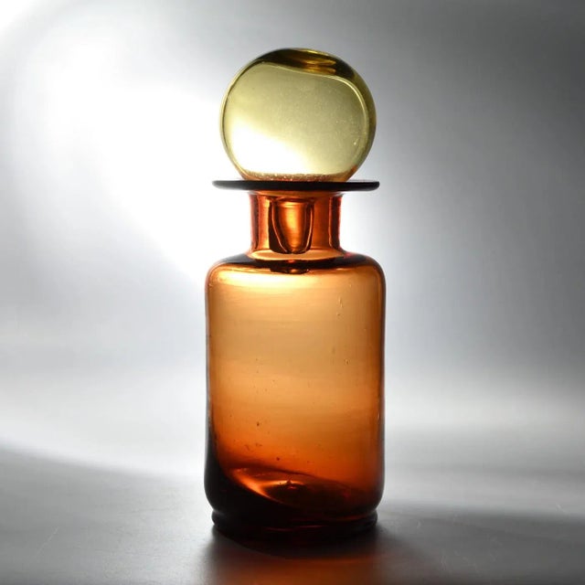 Mid-Century Italian Amber Glass Carafe from Empoli, 1960s, in Very Good conditions. Designed 1960 to 1969 This piece is...