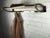 1950s wall-mounted coat rack with 5 hooks and a metal mesh hat shelf.