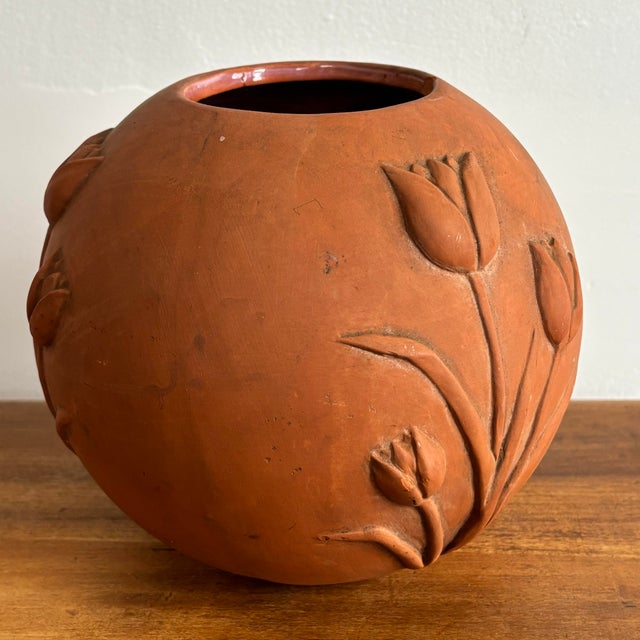 Lovely round terra cotta vase with tulips in relief. Please see condition details noted. Most items found at Pub & Oasis...