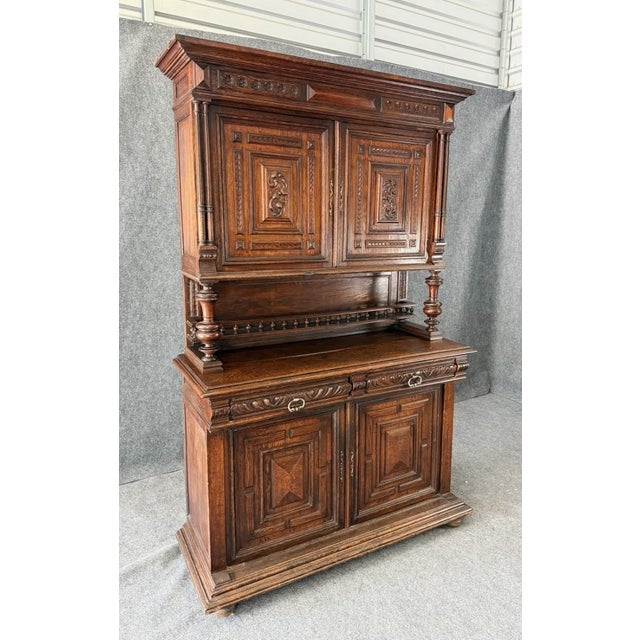This 19th century Belgian court cupboard is a striking statement piece, richly carved with architectural panels, turned...