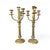 An elegant pair of early 20th-century brass candelabras featuring classic proportions and a beautifully aged patina....