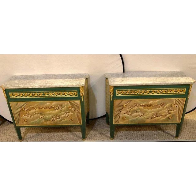 Pair of paint decorated Hollywood Regency marble-top bronze mounted commodes. The green painted case with fine bronze...