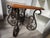 This Ethan Allen coffee table and end tables features a wrought iron accent table styled with a polished wooden top and an...