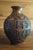 A vintage Persian vase which is done in copper relief and features religious figures on all sides. In very good vintage...
