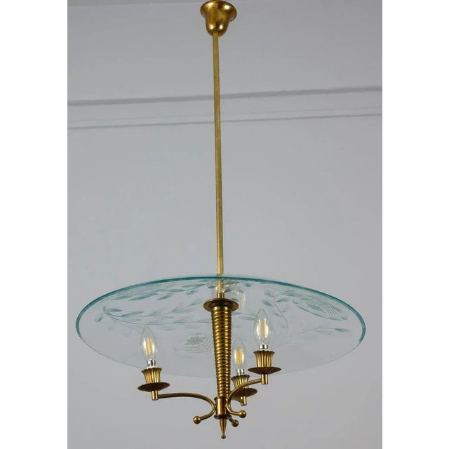 Large precious Nile green crystal etched acid disc supported by a finely chiseled frame. This fixture is attributed to...