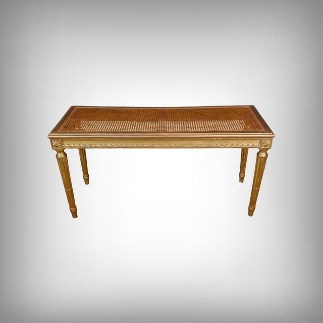 This elegant Louis XVI style piano bench perfectly embodies the refinement and geometric rigor of French Neoclassicism....