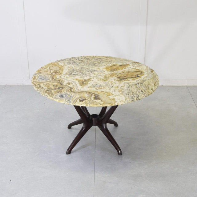 Coffee table by Enrico Ciuti, produced by Cassina in the 1950s. The frame is made of dark Italian walnut and the base is...